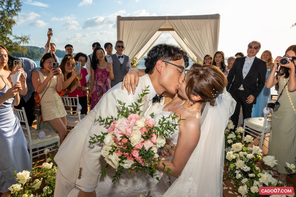 Bride and groom kissing during the wedding ceremony